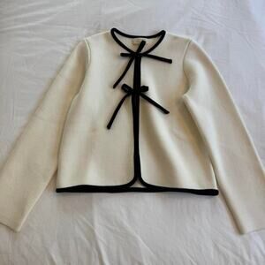 Sezane cream cardigan with and black bow tie sweater